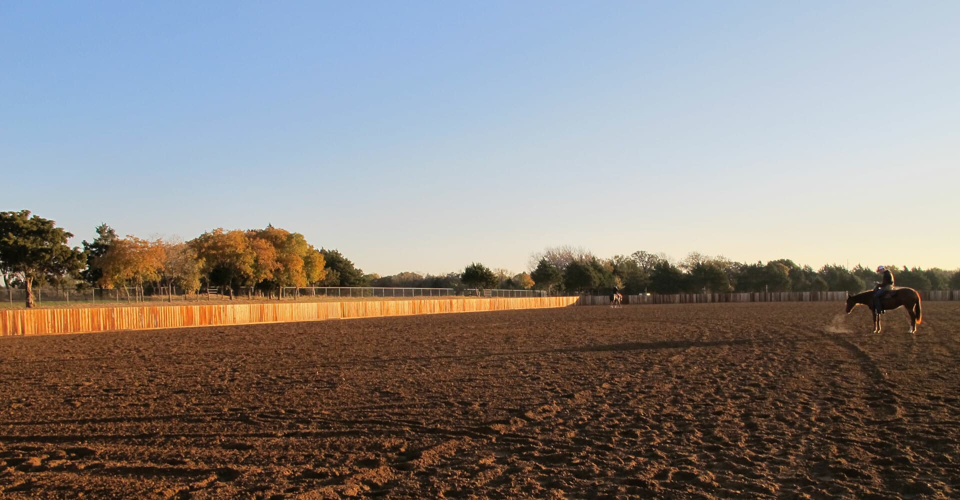 A horse and rider in the outdoor arena at CS Ranch Texas